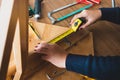 Woman assembly wooden furniture,fixing or repairing house with tape measures.modern living concepts