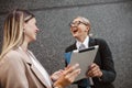 Woman assistant talking and discussing work to businesswoman