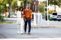 Woman Assisting Blind Man On Street