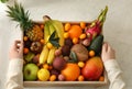 Woman with assortment of exotic fruits at table in kitchen, top view Royalty Free Stock Photo