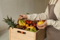 Woman with assortment of exotic fruits at table in kitchen, closeup Royalty Free Stock Photo