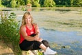 Woman athlete beside pond
