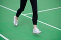 Woman Athlete Runner Feet Running on Green Running Track. Fitness and Workout Wellness Concept.