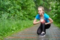 Woman athlete runner touching Knee in pain, fitness woman running in summer park. Healthy lifestyle and sport concept Royalty Free Stock Photo