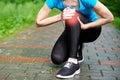 Woman athlete runner touching Knee in pain, fitness woman running in summer park. Healthy lifestyle and sport concept Royalty Free Stock Photo