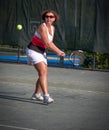 Woman athlete about to hit a tennis ball