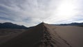Woman Atop Dune Hikes Tward Camera