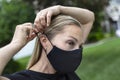 Woman attaching a face mask around her ear