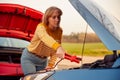 Woman Attaching Jumper Cable To Start Car Engine With Flat Battery Royalty Free Stock Photo