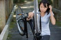 Woman attempting to repair bicycle wheel