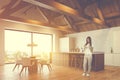 Woman in attic kitchen with bar and table Royalty Free Stock Photo