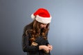 Woman attractive lady wear santa hat. Girl hold box opening christmas gift. Girl celebrate christmas. Girl wear santa claus hat. Royalty Free Stock Photo