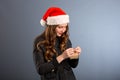 Woman attractive lady wear santa hat. Girl hold box opening christmas gift. Girl celebrate christmas. Girl wear santa claus hat. Royalty Free Stock Photo