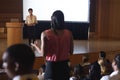 Woman from the audience standing and asking query in the auditorium