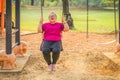 Woman with autistic or down syndrome playing at playground in park