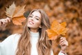 Woman with autumn leaves. Girl with orange leaves. Season and autumn holiday. Beauty and fashion. Smiling model with