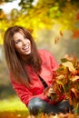 Woman with autumn leaves in hand and fall yellow maple gar Royalty Free Stock Photo