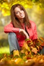 Woman with autumn leaves in hand and fall yellow maple gar Royalty Free Stock Photo