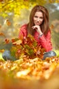 Woman with autumn leaves in hand and fall yellow maple gar Royalty Free Stock Photo