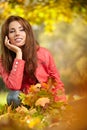 woman with autumn leaves in hand and fall yellow maple gar Royalty Free Stock Photo