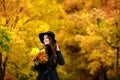 Woman with autumn leaves in hand and fall yellow maple garden background Royalty Free Stock Photo