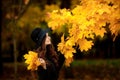 Woman with autumn leaves in hand and fall yellow maple garden background Royalty Free Stock Photo