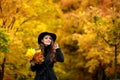 Woman with autumn leaves in hand and fall yellow maple garden background Royalty Free Stock Photo