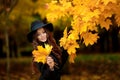 Woman with autumn leaves in hand and fall yellow maple garden background Royalty Free Stock Photo