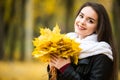 Woman with autumn leaves in hand and fall yellow maple garden background Royalty Free Stock Photo