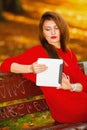 Woman in autumn park using tablet computer reading. Royalty Free Stock Photo