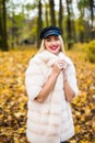 Woman autumn portrait. Fashion girl outdoor. Autumn woman having fun at the park and smiling. young woman portrait in autumn color Royalty Free Stock Photo