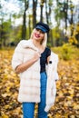 Woman autumn portrait. Fashion girl outdoor. Autumn woman having fun at the park and smiling. young woman portrait in autumn color Royalty Free Stock Photo