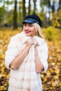 Woman autumn portrait. Fashion girl outdoor. Autumn woman having fun at the park and smiling. young woman portrait in autumn color Royalty Free Stock Photo