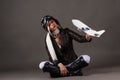 Woman in aviator helmet playing with toy airplane Royalty Free Stock Photo