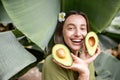 Woman with avocado in banana leaves Royalty Free Stock Photo