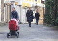 Woman with baby buggy and 2 other passerbys, Sochi Royalty Free Stock Photo