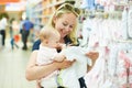 Woman with baby child in clothes shop Royalty Free Stock Photo