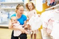 Woman with baby and child in clothes shop Royalty Free Stock Photo