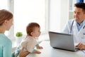 Woman with baby and doctor with laptop at clinic Royalty Free Stock Photo