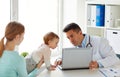 Woman with baby and doctor with laptop at clinic Royalty Free Stock Photo