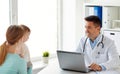 Woman with baby and doctor with laptop at clinic Royalty Free Stock Photo