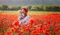 Woman with baby in a field of red poppies