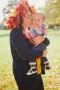 Woman and baby girl outdoors in park Royalty Free Stock Photo