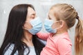 Quarantined woman and baby girl wearing medical masks