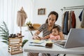 Woman with baby working from home of her online ecommerce shop Royalty Free Stock Photo