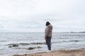 Woman from the back on the beach in cold weather Royalty Free Stock Photo