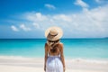 Woman from back on a caribbean beach enjoying her vacation in a sunny day. Travel concept. Generative AI