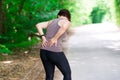 Woman with back pain, kidney inflammation, injury during workout Royalty Free Stock Photo