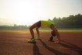 Woman backbending on stadium track