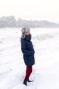 Woman on the background of a winter landscape with large hummocks, frozen ice, Jurmala, Latvia. Winter walk.